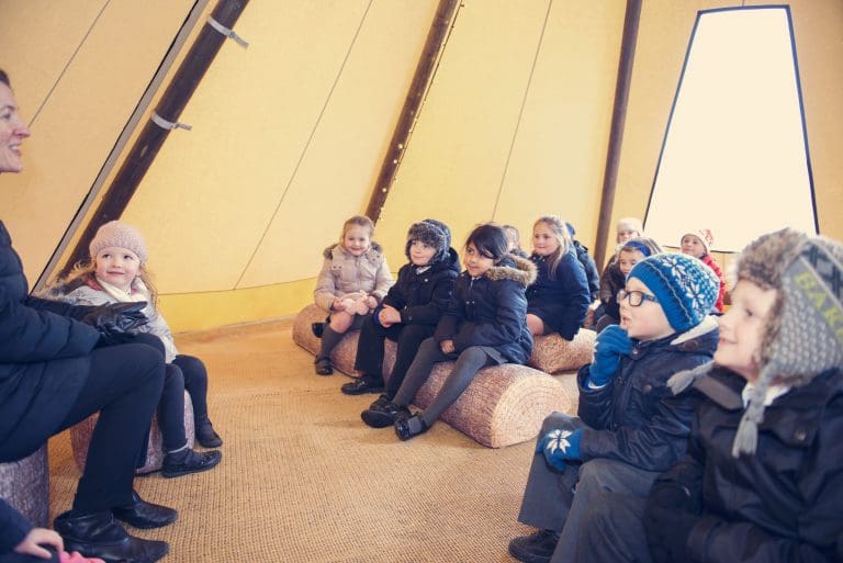 A class of children and teacher enjoying a lesson in a Baby Tipi