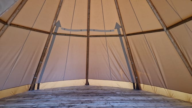 A tent with a wooden floor

AI-generated content may be incorrect., Picture