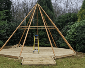 A wooden structure with a ladder in the middle of it

AI-generated content may be incorrect., Picture