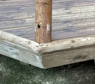 A wooden deck with a pole

AI-generated content may be incorrect., Picture