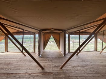 Inside a tent with a wooden floor

AI-generated content may be incorrect., Picture